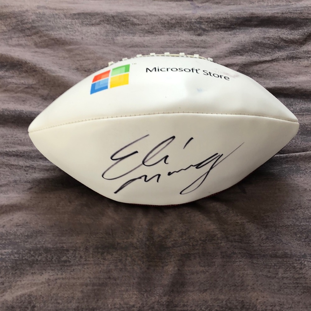 Eli Manning autographed football from Microsoft retail store launch. Small stain